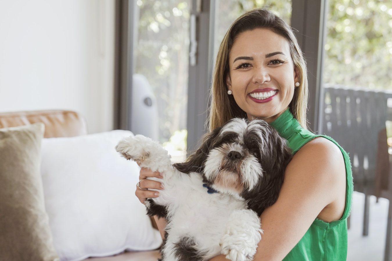 Brazilian woman and her pet shih tzu dog at home, making video call